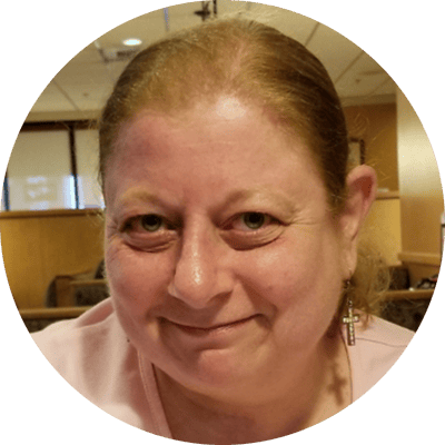 Smiling woman with earrings in dining area