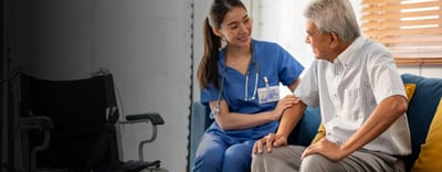 Nurse interacting with an elderly man in a cozy interior.