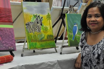Resident showcasing artwork during an activity.