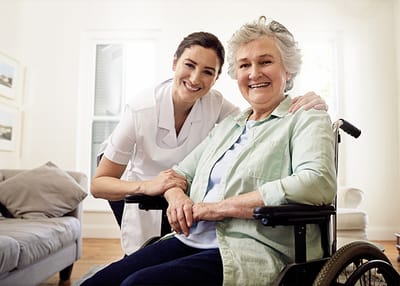 Smiling caregiver and elderly resident together