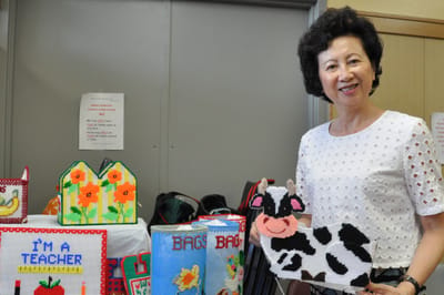 Woman displaying handmade items in facility interior