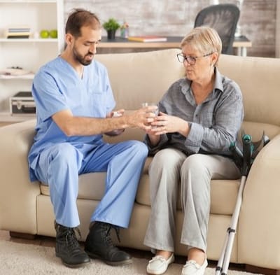 Caregiver assisting a resident with medication.