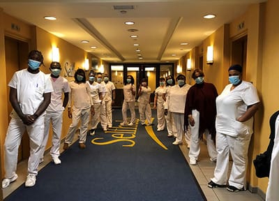 Staff members in scrubs standing in a hallway