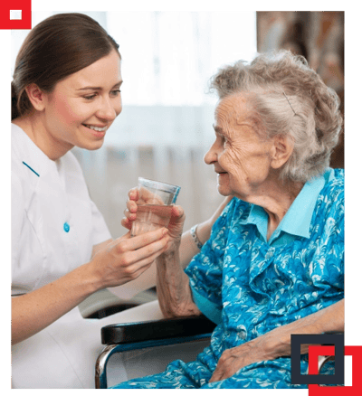 Caregiver smiling with elderly resident