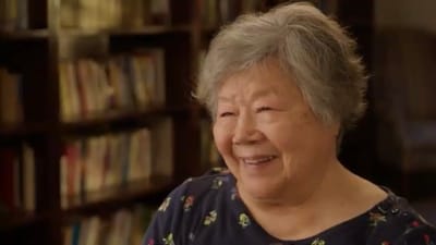 Smiling senior woman in a library setting.