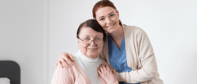 Caregiver and resident smiling together