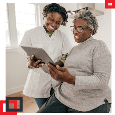 Staff assisting a resident with a tablet