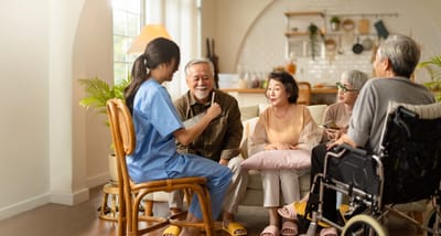 Senior residents engaged in conversation with staff