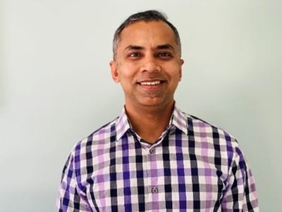 Smiling man in a checkered shirt