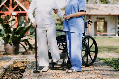 Caregiver assisting a resident outdoors