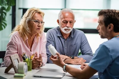 Couple discussing medication with a healthcare professional