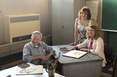 Residents and staff engaged in an art activity.