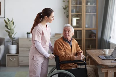Caregiver assisting an elderly man in a living space.