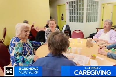 Residents engaged in a group activity at a table.