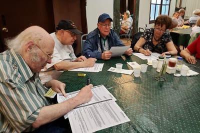 Seniors engaged in an activity at a table.