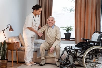Nurse assisting an elderly man in a cozy room.