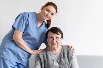 Caregiver with resident in a cozy indoor setting.