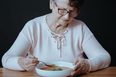 Senior woman enjoying a bowl of soup