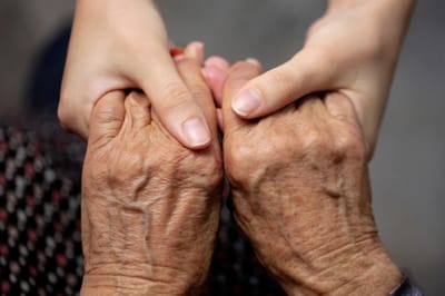 Two hands clasped together in support.
