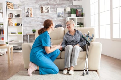 Caregiver interacting with a resident in a cozy setting.