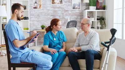 Healthcare professionals interacting with a senior man