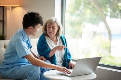 Caregiver assisting a senior resident indoors