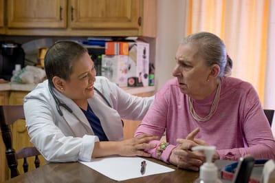 Nursing staff interacting with a resident at home