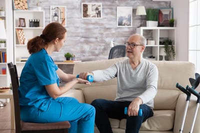 Occupational therapist assisting a senior male resident