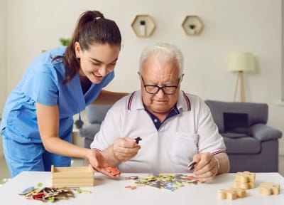 Staff assisting a resident with a puzzle activity.