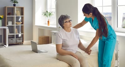 Caregiver assisting a resident in a room