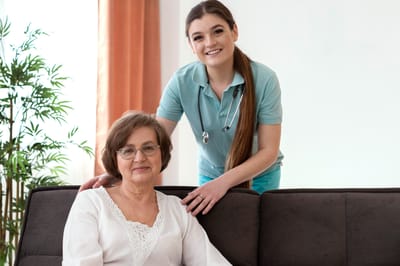 Nurse assisting a resident in a comfortable setting.