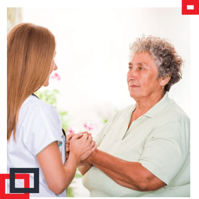 Nurse holding hands with elderly resident
