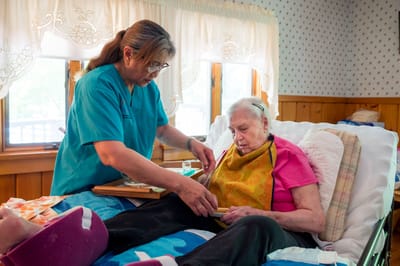 Caregiver assisting a resident in a personal space