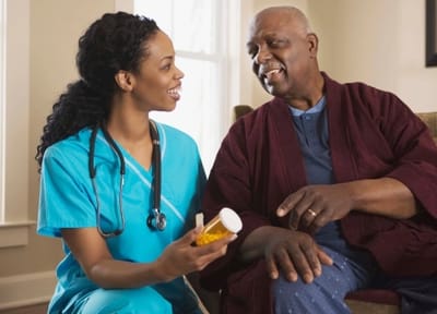 Nurse discussing medication with senior resident