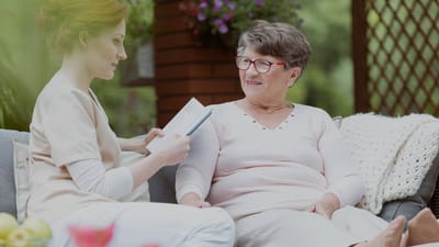 Caregiver and resident interacting outdoors