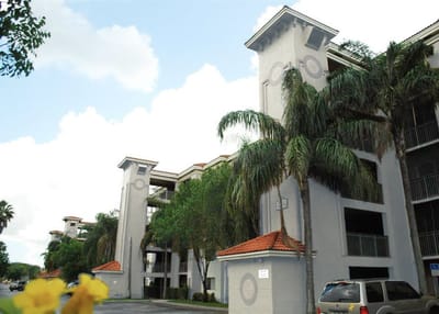 Exterior view of the Heron Pointe facility with palm trees