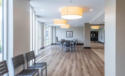 Bright common area with seating and large windows