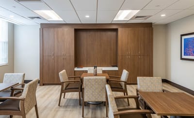 Common area with tables and chairs in a warm setting
