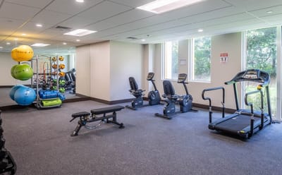 A well-equipped fitness room with exercise equipment