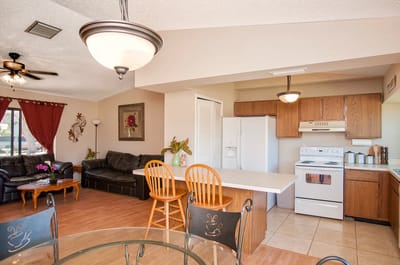 Bright and spacious common area with seating and kitchen