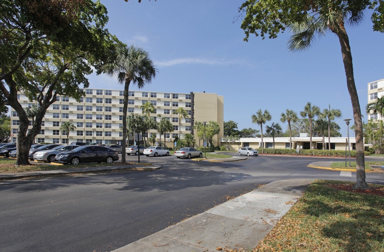 Exterior view of St. Andrews Towers with palm trees and parking lot