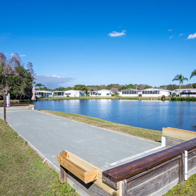 Outdoor space with a view of the lake and nearby homes