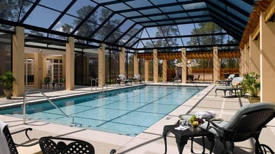 Indoor pool area with sunlit seating