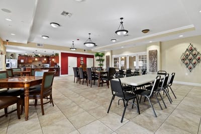 Dining area with tables and chairs in a bright setting