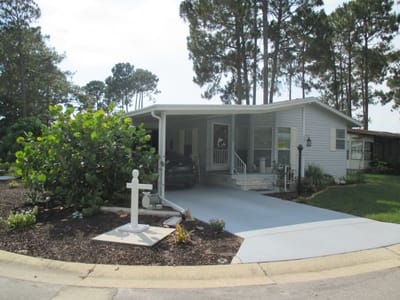 Exterior view of a facility home surrounded by greenery