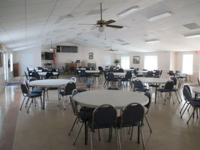 Interior view of a large common area with tables and chairs