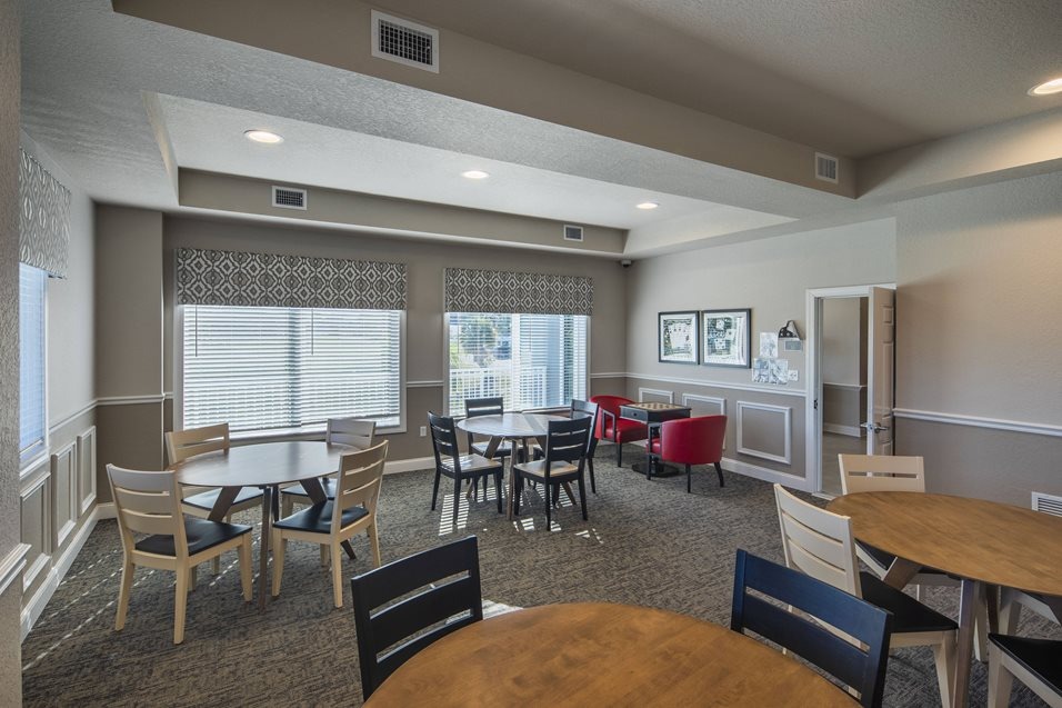Bright common area with seating and tables