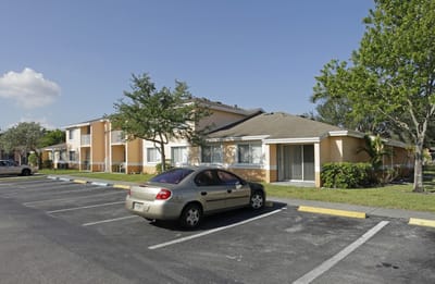 Exterior view of a senior living facility with parking