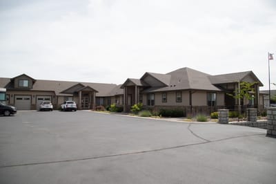 Exterior view of Providence Senior Home with parking area