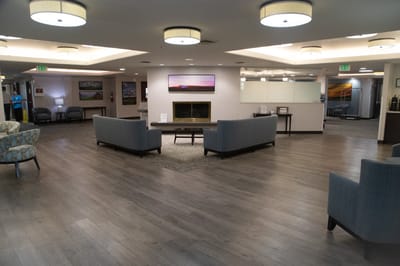 Common area with seating and fireplace in a bright lobby